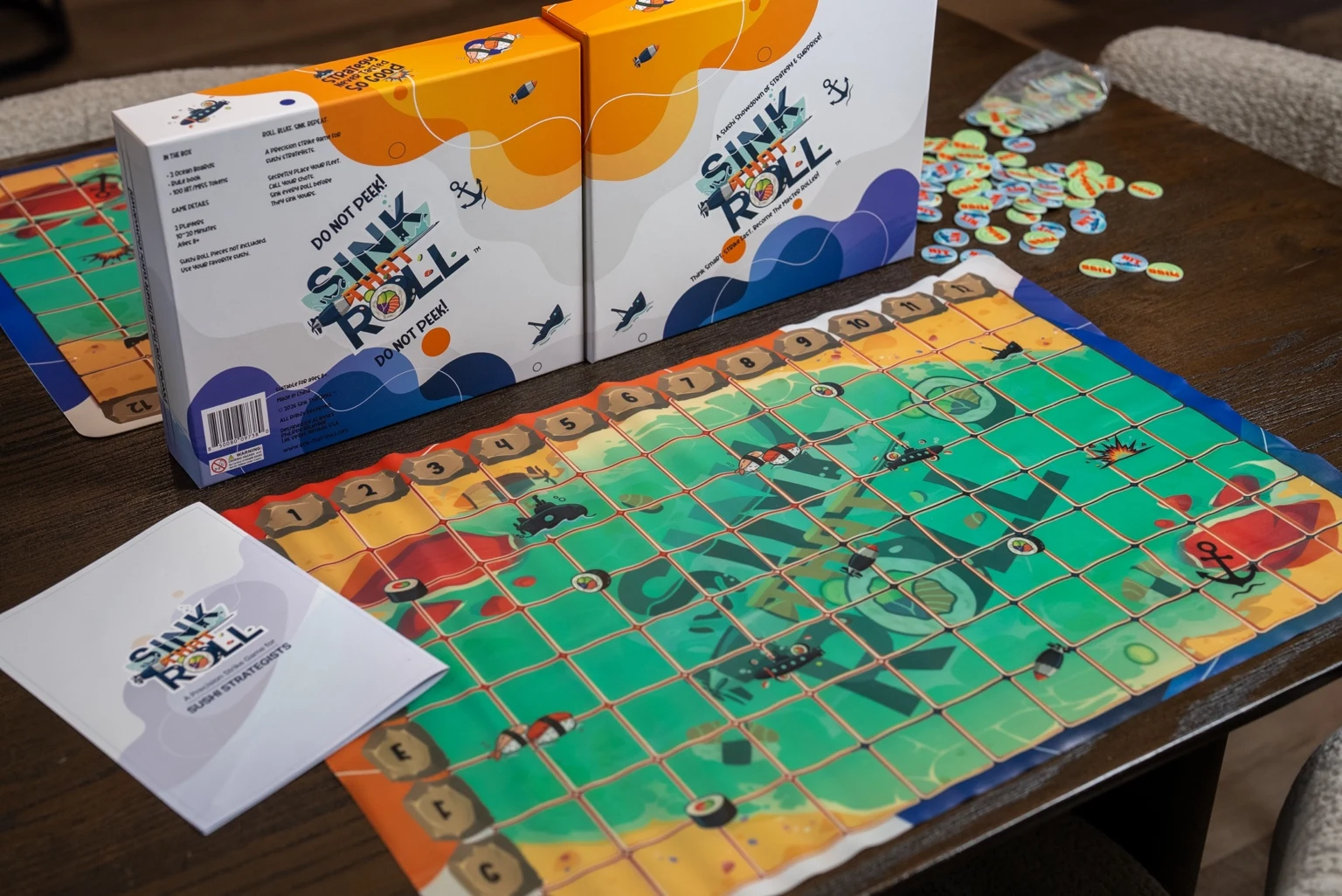 Sink That Roll 8 by 12 game board with captain screens, tokens and instructions on a table